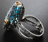 Серебряное кольцо с голубым топазом, рубинами и синими сапфирами Серебро 925