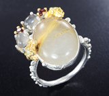 Серебряное кольцо с рутиловым кварцем, лунным камнем, голубым топазом и родолитами