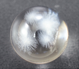 Сфера бесцветного кварца с резными «снежинками» 14,3 карата 