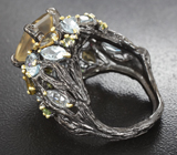 Серебряное кольцо с флюоритом, родолитом, голубыми топазами, желтыми турмалинами и перидотами