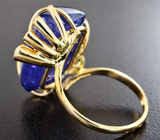 Золотое кольцо с крупным насыщенным танзанитом 22,99 карата и синими сапфирами Золото