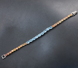 Элегантный серебряный браслет с голубыми топазами и золотистыми сапфирами