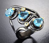 Серебряное кольцо с голубыми и бесцветными топазами