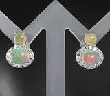 Эффектные серебряные серьги с кристаллическими эфиопскими опалами и бесцветными топазами