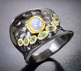 Серебряное кольцо с кристаллическим эфиопским опалом и голубыми топазами