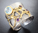 Серебряное кольцо с голубым топазом и аметистами