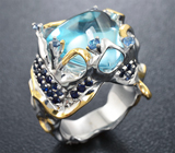 Серебряное кольцо с голубым топазом авторской огранки и синими сапфирами 