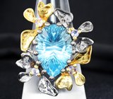 Серебряное кольцо с голубым топазом лазерной огранки 12,58 карата и танзанитами