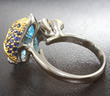 Серебряное кольцо с голубым топазом лазерной огранки 8,84 карата, аквамаринами и синими сапфирами