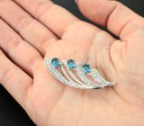 Изысканная серебряная брошь с голубыми топазами