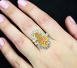 Серебряное кольцо с резным цитрином и голубыми топазами